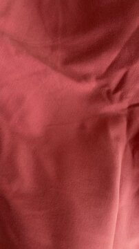 Coral orange fabric texture with soft folds and natural creases