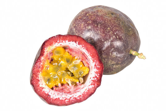 Fresh Whole and Halved Passion Fruit showing Juicy Yellow Pulp and Seeds