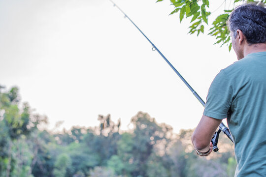 Man fishing serene nature landscape.
