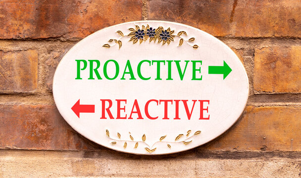 Proactive and reactive symbol. Concept word Proactive Reactive on beautiful white sign plate. Beautiful brick wall background. Business proactive and reactive concept. Copy space.