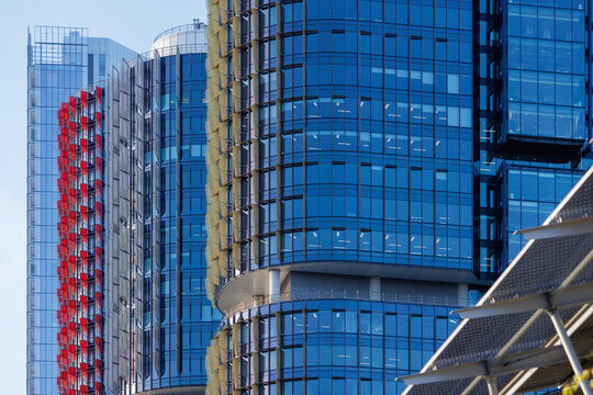 View of layered Barangaroo office towers with red and blue glass facades