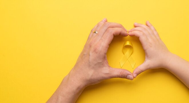 Adult and Child Hands Forming Heart Around Yellow Awareness Ribbon