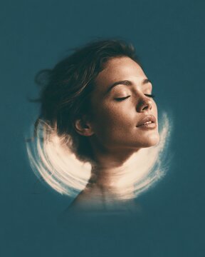 Woman with closed eyes surrounded by swirling light energy