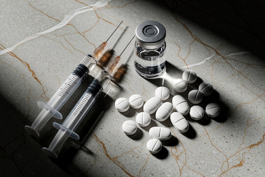 Two syringes vial of liquid and white pills arranged on a marbled surface. Medical items used for treatments and therapies. Science and healthcare objects.