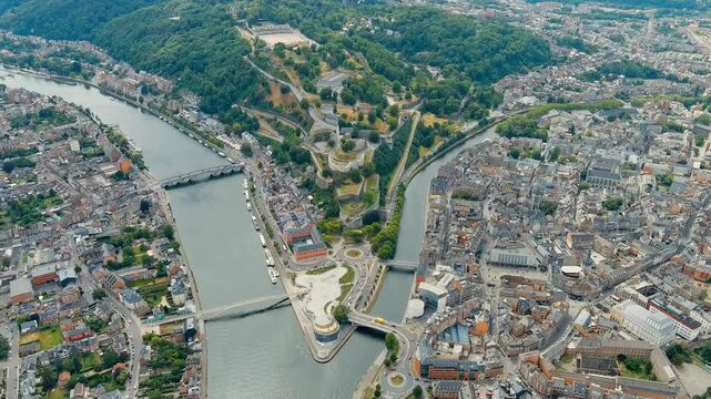 Namur, Belgium. Citadelle de Namur - 10th-century fortress with a park, rebuilt several times. Panorama of the central part of the city. River Meuse. Summer day. Drone footage