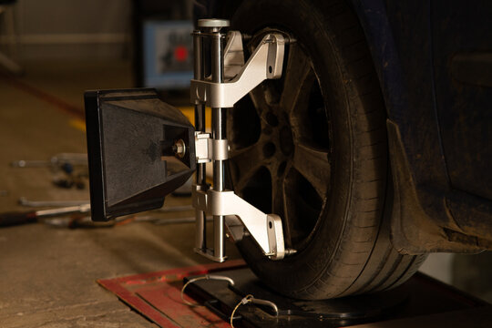 Car wheel alignment clamp with target mounted on tire.
