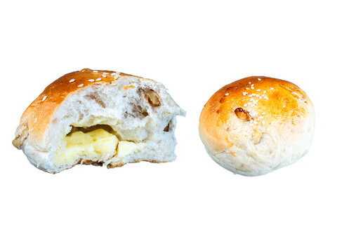 Cut filled bakery bun showing stuffing and whole bread roll isolated on transparent background.