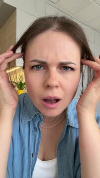 Curious young woman leaning closer with doubtful look then having aha moment with happy surprised expression, 4k vertical