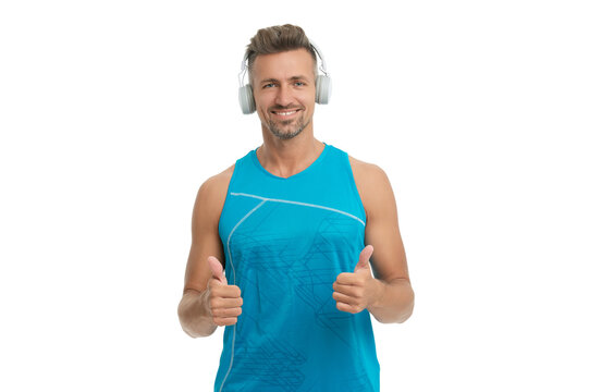 Fitness sportswear for man. Music and fitness lifestyle. Thumb up. Sport and fitness. Mature man in sportswear. Fit and active man workout isolated on white. Sporty man do sport with music