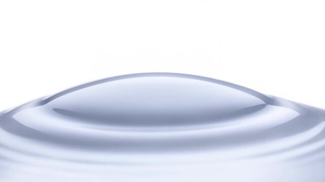 Black Reflective Sphere Hovering Above White Circular Basin in Minimal Studio Setting