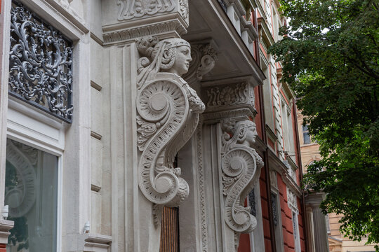 Historical building decoration in form of brackets with female mascarons