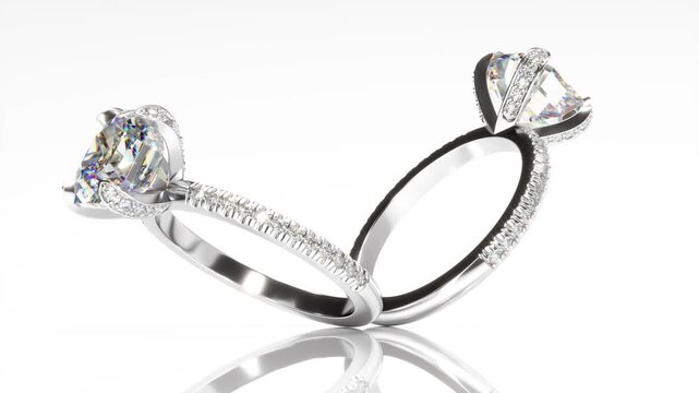 Rotation of engagement rings mockup with large radiant cut diamond on white background. As the rings rotates, the sketch changes to a finished white gold rings. 3d animation