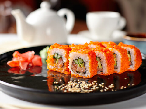 Closeup of a round plate with a serving of Japanese rolls. Selective focus.