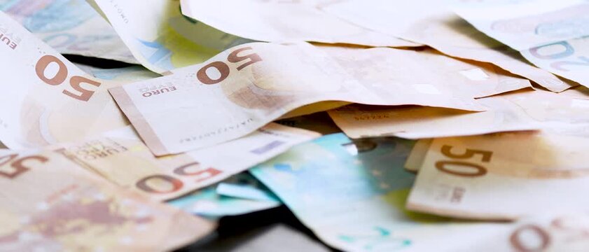 Top view of euro banknotes scattered over table cash money financial success concept
