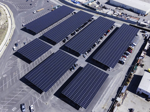 Aerial view of the large-scale solar panel carports covering the parking lots at Six Flags Magic Mountain in Valencia, California, United States.