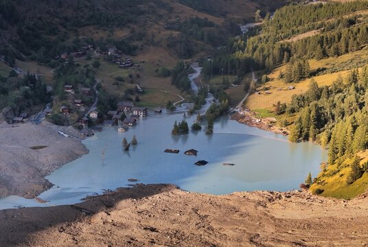 Aerial view of the aftermath of a catastrophic rock and ice avalanche that flooded the village, with submerged houses and debris visible in the glacial lake, Blatten, Wallis, Switzerland.