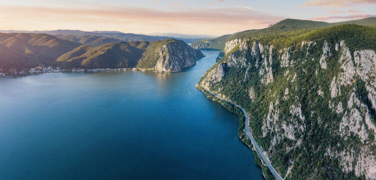 Danube River flowing through the Iron Gates gorge, forming a natural border between Serbia and Romania, with steep cliffs and green forests