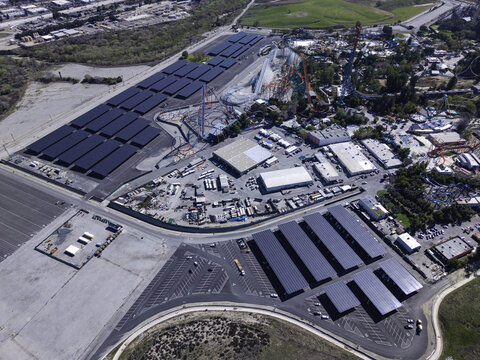 Aerial view of the extensive solar panel arrays covering the parking lots at Six Flags Magic Mountain amusement park in Valencia, California, United States.
