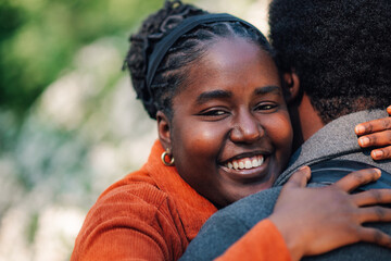African american woman embracing man, sharing happy moment, feeling love and connection in a...