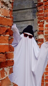 Ghost in sunglasses between weathered brick walls