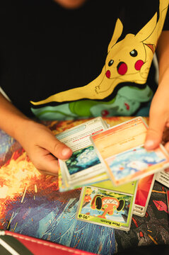 Chicago, IL/USA - August 27, 2026: Child looking through recently opened Pokemon Stellar Crown trading cards