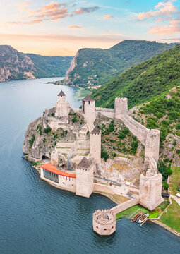 Majestic Golubac Fortress stands sentinel over the sweeping Iron Gates gorge at dusk in Seriba