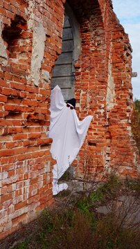 Halloween ghost in haunted abandoned brick ruin