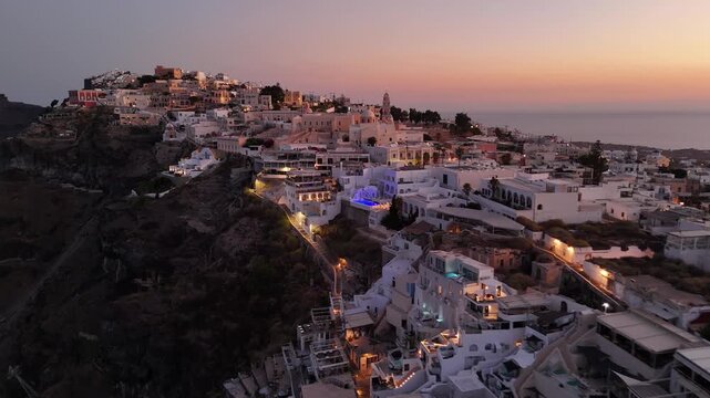 Sunset view of the cliffside village Fira in Santorini Greece at dusk