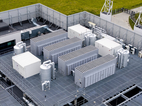 Aerial view of an AI data center featuring industrial cooling units, ventilation systems, and technical infrastructure on a rooftop in Poland.