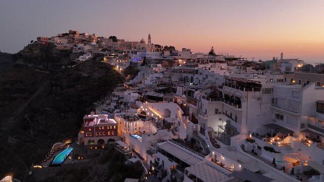 Beautiful sunset view over the white buildings of Fira in Santorini Greece
