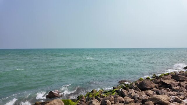 Turquoise Sea Waves Breaking Against Rocky Rameswaram Shoreline in Tamil Nadu