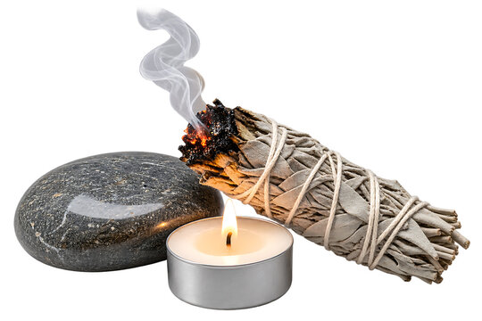 White sage smudge stick with burning smoke, zen basalt stone and tea light candle. Spiritual cleansing ritual items on white background.