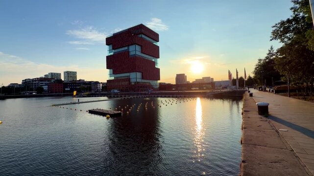 The MAS Museum in Antwerp, Belgium at sunset with reflections on the water