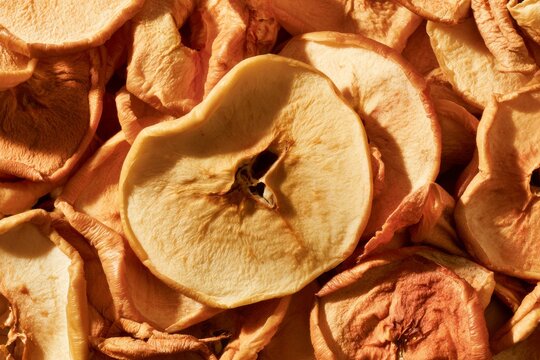 Dried apple slices arranged in a pile showing their texture and color