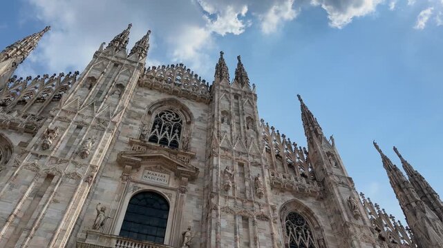 Gothic spires of Milan Duomo beneath blue sky