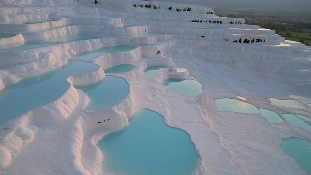 Travertine terraces with turquoise water during sunset with cinematic gentle camera movement