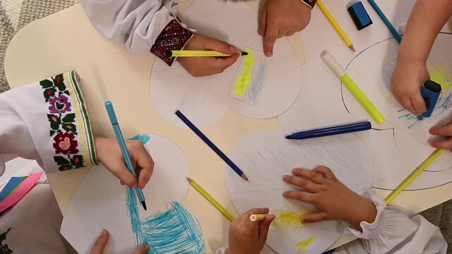 Children creating art inspired by the colors of Ukraine in a joyful classroom setting
