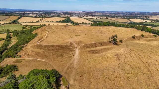 An aerial receding view from the remains of the Iron Age Hillfort in rural Leicestershire, UK in late summertime