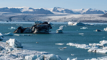 A beautiful icebergs breaking from Vatnajokull glacier and drifting across Jokulsarlon lagoon, Iceland, creating beautiful abstract shapes that reflect glacier melt and global warming in summer. © Asanee