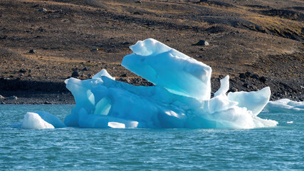 A beautiful icebergs breaking from Vatnajokull glacier and drifting across Jokulsarlon lagoon, Iceland, creating beautiful abstract shapes that reflect glacier melt and global warming in summer. © Asanee