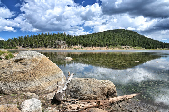 Echo Lake in the Colorado Rocky Mountains with pine trees, blue sky and clouds, Idaho Springs CO