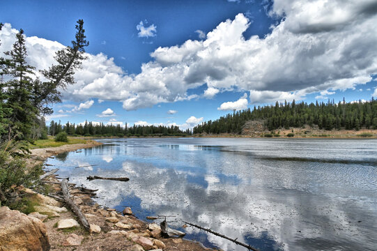 Echo Lake in the Colorado Rocky Mountains with pine trees, blue sky and clouds, Idaho Springs CO
