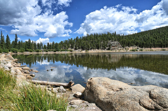 Echo Lake in the Colorado Rocky Mountains with pine trees, blue sky and clouds, Idaho Springs CO