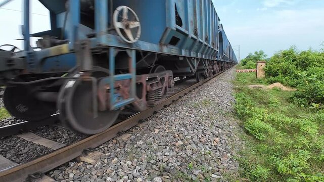 Indian Freight Train Moving On Railway Track Low Angle Wheel Close Up. Blue Goods Train Bogie Wheels Rolling On Track In India.