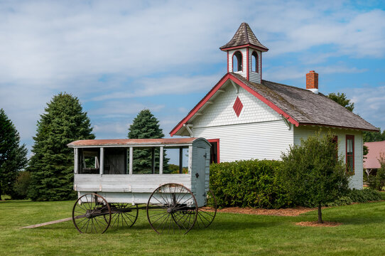 Wooden School Wagon Parked Outside Schoolhouse
