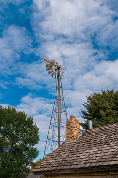 Old Windmill Looms Over Farm Buildings