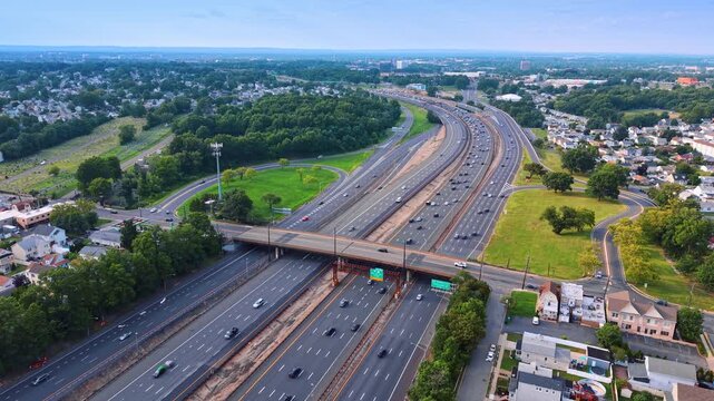 Crazy traffic on the wide motor vehicle highways. Descend over the highways across the green cityscape of Middlesex County, New Jersey.
