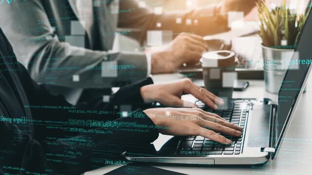 Two programmers collaborate in a modern office, focusing on laptop screens filled with code and coffee. The scene reflects productivity and teamwork in a tech environment. Xenic