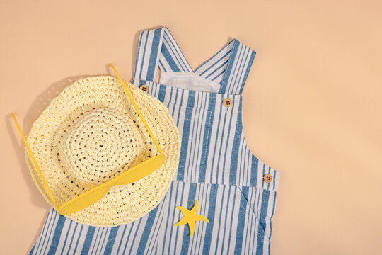 Concept of a safe beach vacation and careful childcare during a holiday. Baby summer flat lay