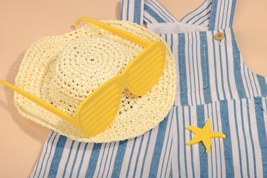 Concept of a safe beach vacation and careful childcare during a holiday. Baby summer flat lay